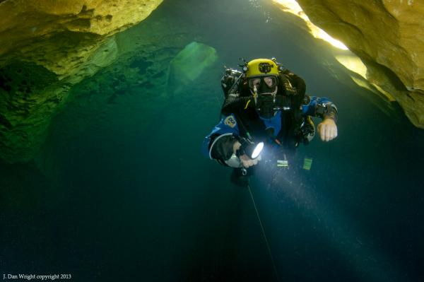 John Katerenchuk doing deco after a 265' cave dive into Eagle's Nest, along the upstream section. The chimney entrance can be seen in the center of this image.